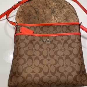 Coach north south messenger crossbody bag in orange and tan